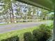 Scenic water view featuring a tranquil lake lined with mature trees and manicured landscaping at 105 Temple W Cv, Leesburg, FL 34748