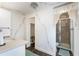 Well-lit bathroom features floral wallpaper accents, a window, a shower, a sink, and a toilet at 1113 Elkhart Cir, Tavares, FL 32778