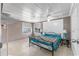 Comfortable bedroom featuring tiled floors, two windows, ceiling fan, and a decorative metal bed frame at 1113 Elkhart Cir, Tavares, FL 32778