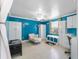 Blue bedroom with matching wardrobe and bench plus a white chaise lounge at 1113 Elkhart Cir, Tavares, FL 32778