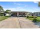 Inviting single-story home with a covered carport and well-manicured landscaping, plus a concrete driveway at 1113 Elkhart Cir, Tavares, FL 32778