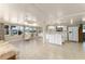Spacious, open-concept kitchen and living area with tiled flooring and abundant natural light from large windows at 1113 Elkhart Cir, Tavares, FL 32778