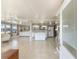 Bright, open-concept kitchen featuring modern white cabinets, stainless steel appliances, and tiled flooring at 1113 Elkhart Cir, Tavares, FL 32778