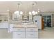 Spacious kitchen showcasing a center island, white cabinets, and ample counter space at 1113 Elkhart Cir, Tavares, FL 32778