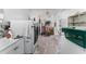 Functional laundry room with multiple machines, a sink, and ample storage space at 1113 Elkhart Cir, Tavares, FL 32778