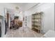 Bright laundry area with machines, storage cabinets, shelving, and painted floor at 1113 Elkhart Cir, Tavares, FL 32778