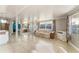 Bright living room featuring tile floors, large windows for natural light, and a comfortable seating area at 1113 Elkhart Cir, Tavares, FL 32778