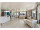 Bright living room with tile floors, neutral walls, and a comfortable floral sofa at 1113 Elkhart Cir, Tavares, FL 32778