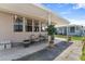 Cozy outdoor patio area with seating and a covered roof at 1113 Elkhart Cir, Tavares, FL 32778