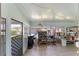 Enclosed porch with tiled floor, storage shelves, and screen door providing outdoor views at 1113 Elkhart Cir, Tavares, FL 32778