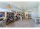 Spacious sunroom with shelving, patterned floor, and access to laundry area at 1113 Elkhart Cir, Tavares, FL 32778