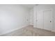 Bedroom with neutral carpet, baseboards, white walls, and a large closet at 1191 Stratton Ave, Groveland, FL 34736