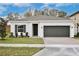 Charming single-story home featuring a two-car garage and well-manicured lawn at 1191 Stratton Ave, Groveland, FL 34736