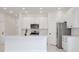 Stylish kitchen with white cabinets, stainless steel appliances, and a breakfast bar at 1191 Stratton Ave, Groveland, FL 34736