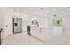 Bright, open kitchen with stainless steel appliances and a large center island at 1191 Stratton Ave, Groveland, FL 34736