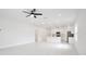 Open-concept living space showcasing bright lighting, tile floors and a modern kitchen at 1191 Stratton Ave, Groveland, FL 34736