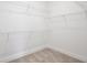 Walk-in closet featuring metal shelving, neutral carpet, and white walls at 1191 Stratton Ave, Groveland, FL 34736