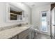 Bathroom with a granite countertop, wood-look shower, and direct patio access at 12838 Owasso Ln, Clermont, FL 34711