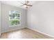 Inviting bedroom with vaulted ceilings, wood floors, and a large window, creating a serene atmosphere at 12838 Owasso Ln, Clermont, FL 34711