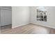 Bright bedroom with laminated floors, a window with garden view and a closet at 12838 Owasso Ln, Clermont, FL 34711