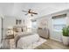 Serene bedroom with tray ceiling, neutral tones, and comfortable furnishings at 12838 Owasso Ln, Clermont, FL 34711