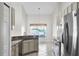 Bright kitchen with stainless steel appliances, and a stylish backsplash at 12838 Owasso Ln, Clermont, FL 34711