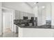 Modern kitchen featuring stainless steel appliances, granite countertops, and ample cabinet space at 12838 Owasso Ln, Clermont, FL 34711