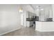 Well-lit kitchen features stainless steel appliances, stone countertops, tile backsplash, and tiled floors at 12838 Owasso Ln, Clermont, FL 34711