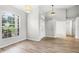 Bright living room featuring wood floors, a large window, and stylish light fixtures, offering a welcoming space at 12838 Owasso Ln, Clermont, FL 34711
