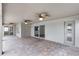 Expansive covered patio with stylish pavers, multiple ceiling fans, and outdoor access at 12838 Owasso Ln, Clermont, FL 34711