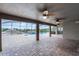 Spacious covered patio offering views of the screened-in pool and lush surroundings at 12838 Owasso Ln, Clermont, FL 34711