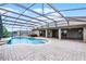 Screened-in pool with brick patio and outdoor hot tub, perfect for relaxing and entertaining at 12838 Owasso Ln, Clermont, FL 34711
