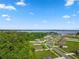Aerial view of the community showcasing the beautiful surroundings with lake and trees at 12952 Del Lago Dr, Astatula, FL 34705
