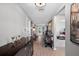 Spacious hallway with wood floors, decorated with a console and leads to other areas of the home at 12952 Del Lago Dr, Astatula, FL 34705