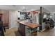 Modern kitchen with a stainless steel refrigerator, wood island, and decorative elements at 12952 Del Lago Dr, Astatula, FL 34705