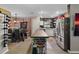 Kitchen with a butcher block island, wine rack, stainless steel appliances, and wood-style tile flooring at 12952 Del Lago Dr, Astatula, FL 34705