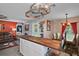 Open kitchen design with butcher block island, stainless appliances, and dining area at 12952 Del Lago Dr, Astatula, FL 34705