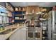 Close-up of modern kitchen with stainless steel appliances and decorative shelving at 12952 Del Lago Dr, Astatula, FL 34705