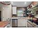 Kitchen with stainless steel appliances, granite countertops, and stylish shelving at 12952 Del Lago Dr, Astatula, FL 34705
