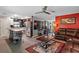 Spacious living area with open kitchen, hardwood floors, stainless steel appliances, and a cozy leather sofa at 12952 Del Lago Dr, Astatula, FL 34705