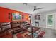 Inviting living room with a comfortable leather sofa, stylish coffee table, and bright accent wall at 12952 Del Lago Dr, Astatula, FL 34705