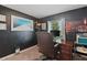 Office space with a large desk, chair, and natural light from the window at 12952 Del Lago Dr, Astatula, FL 34705