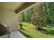 Covered patio overlooks the backyard with a beautiful tree and space for grilling at 12952 Del Lago Dr, Astatula, FL 34705