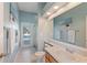 Bright bathroom featuring a door that leads to the pool area and a glass-enclosed shower at 13100 Lakewind Dr, Clermont, FL 34711