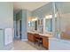 Bathroom featuring a double vanity, shower, and tile flooring and a connecting toilet room at 13100 Lakewind Dr, Clermont, FL 34711