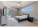 Bedroom boasts neutral walls, a ceiling fan and a sliding glass door to the outdoor pool at 13100 Lakewind Dr, Clermont, FL 34711