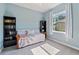 Bright bedroom featuring a daybed, bookshelves, and a window for natural light at 13100 Lakewind Dr, Clermont, FL 34711