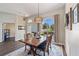Dining room featuring hardwood floors, decorative rug, large windows and modern chandelier at 13100 Lakewind Dr, Clermont, FL 34711