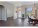 Dining area with hardwood floors, arched windows, and a view of the front yard at 13100 Lakewind Dr, Clermont, FL 34711