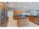 Well-equipped kitchen with stainless steel appliances, granite countertops, and ample cabinet space at 13100 Lakewind Dr, Clermont, FL 34711